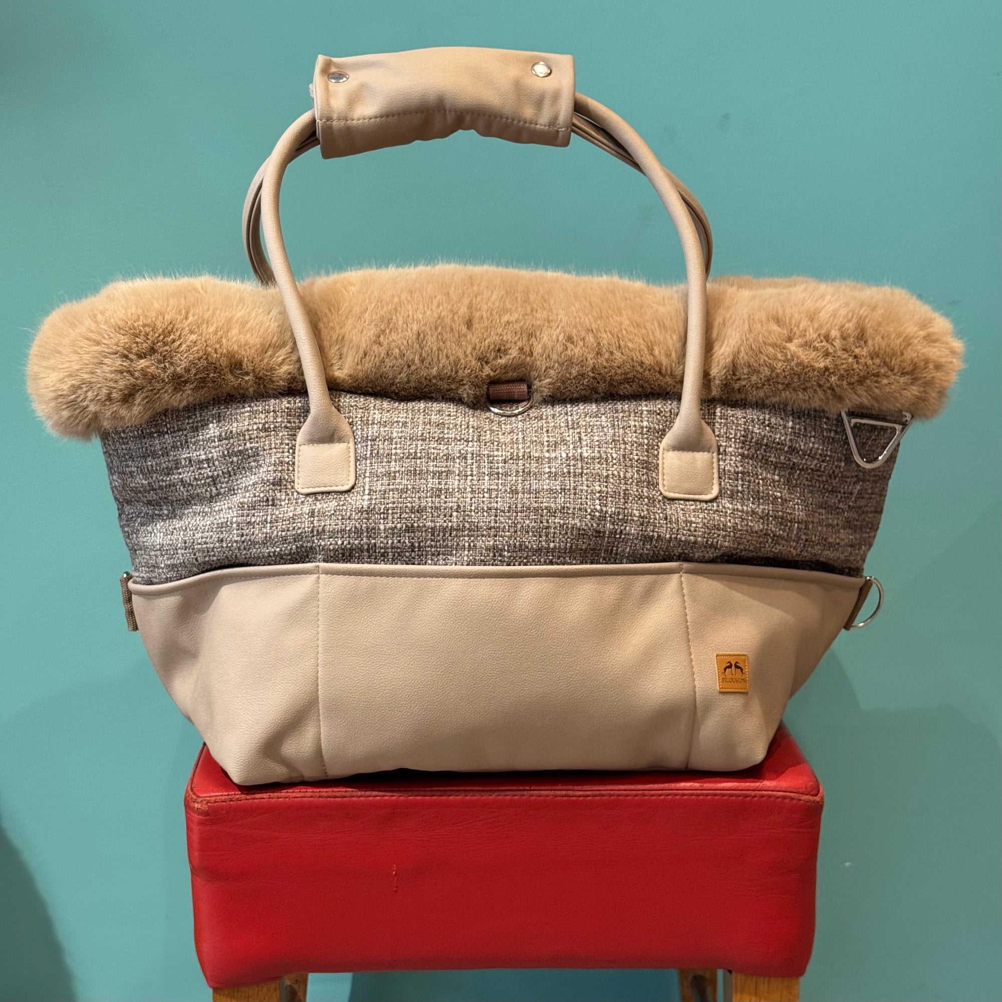 Eine Hundetasche auf einem roten Hocker 