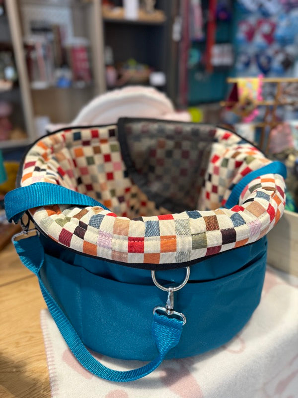 Hundetragetasche von Isarhudn. Außen Petrol, innen buntes Karomuster